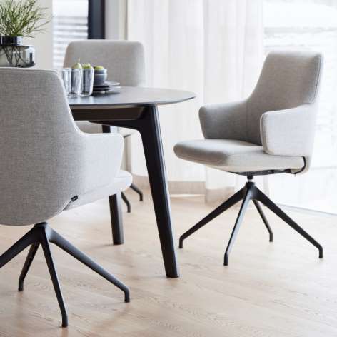 Stressless Laurel dining chair with a grey metal swivel base and arms